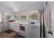 Simple laundry room with washer, dryer, and cabinets at 908 Pomelo Ave, Sarasota, FL 34236