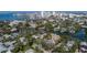 Aerial view of waterfront homes and lush landscape, showcasing the neighborhood's beauty and location at 908 Pomelo Ave, Sarasota, FL 34236