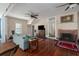 Living room with hardwood floors, fireplace, and comfortable seating at 908 Pomelo Ave, Sarasota, FL 34236