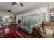 Living room with hardwood floors, ceiling fan, and sunroom access at 908 Pomelo Ave, Sarasota, FL 34236