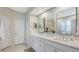 Double vanity bathroom with quartz countertops and large mirrors at 5011 60Th E Dr, Bradenton, FL 34203