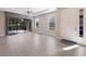 Spacious living room with tile floors and access to backyard at 8720 Bellussi Dr, Sarasota, FL 34238