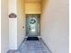 Elegant entryway with decorative glass door and a welcoming wreath at 5606 Mulligan Way, Lakewood Ranch, FL 34211