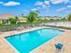 Community pool with plenty of lounge chairs and patio furniture at 22324 Wexford Blvd, Venice, FL 34293