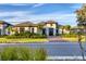 Beautiful two-story home with palm trees and driveway at 1209 Blue Shell Loop, Sarasota, FL 34240