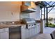 Stainless steel grill, granite countertops, and built-in refrigerator at 1209 Blue Shell Loop, Sarasota, FL 34240