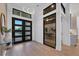 Bright entryway with modern double doors and hardwood floors at 1209 Blue Shell Loop, Sarasota, FL 34240