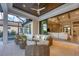 Relaxing outdoor patio with wicker furniture and access to the pool and living area at 1209 Blue Shell Loop, Sarasota, FL 34240