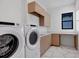 Laundry room with washer, dryer, and ample counter space at 1209 Blue Shell Loop, Sarasota, FL 34240