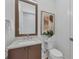 Stylish powder room with modern vanity and art at 1209 Blue Shell Loop, Sarasota, FL 34240