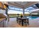 Enjoy this backyard oasis with a pool, outdoor kitchen and lake view at 1209 Blue Shell Loop, Sarasota, FL 34240
