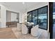 Modern dining room with large windows and access to outdoor patio at 1209 Blue Shell Loop, Sarasota, FL 34240