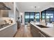 Modern kitchen with large island, breakfast bar, and water views at 1209 Blue Shell Loop, Sarasota, FL 34240
