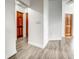 Hallway featuring modern wood-look floors and classic wood doors at 12 Brentwood Ln, Englewood, FL 34223