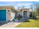 One-story home with blue front door and manicured landscaping at 1777 Gantry Rd, North Port, FL 34288