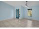 Bright dining area with light blue walls, tile floor, and a view to the front yard at 1777 Gantry Rd, North Port, FL 34288