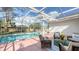 Relaxing screened-in pool area with patio furniture at 1789 Loma Linda St, Sarasota, FL 34239