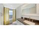 Bathroom with a shower-tub combo, gray counters, a white sink, and a patterned yellow curtain at 1789 Loma Linda St, Sarasota, FL 34239