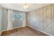 Bedroom with hardwood floors, accent wall, a window with curtains, and a ceiling fan at 1789 Loma Linda St, Sarasota, FL 34239