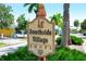 Sign for Southside Village Shops with palm trees and greenery in the background at 1789 Loma Linda St, Sarasota, FL 34239