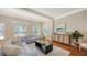 Living room with hardwood floors, light walls, and a large window at 1789 Loma Linda St, Sarasota, FL 34239