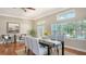 Bright dining room with hardwood floors, large windows, and seating for six at 1789 Loma Linda St, Sarasota, FL 34239