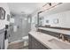 Modern bathroom with double vanity and glass shower at 2100 Benjamin Franklin Dr # 205, Sarasota, FL 34236