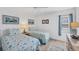 Guest bedroom with twin beds and coastal decor at 2100 Benjamin Franklin Dr # 205, Sarasota, FL 34236