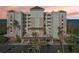 Multi-story condominium exterior featuring balconies and a porte cochere at sunset at 2715 Terra Ceia Bay Blvd # 201, Palmetto, FL 34221