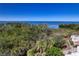 Exterior view showing waterfront scenery with lush foliage with greenery, a patio and railings at 2715 Terra Ceia Bay Blvd # 201, Palmetto, FL 34221