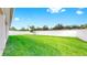 Large, grassy backyard featuring a white fence and well-kept lawn at 3718 Mossy Limb Ct, Palmetto, FL 34221