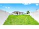 Well-maintained backyard with lush green grass and a white privacy fence at 3718 Mossy Limb Ct, Palmetto, FL 34221
