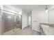 This bathroom features a glass-enclosed shower, granite countertops, and a neutral color scheme at 3718 Mossy Limb Ct, Palmetto, FL 34221