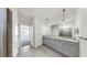This bathroom features a double sink vanity, granite countertops, and a glass-enclosed shower at 3718 Mossy Limb Ct, Palmetto, FL 34221