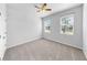 This bedroom features neutral carpet, a ceiling fan, and windows with lots of natural light at 3718 Mossy Limb Ct, Palmetto, FL 34221
