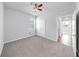 Neutral bedroom featuring plush carpet, ceiling fan, double closet, and a bright window at 3718 Mossy Limb Ct, Palmetto, FL 34221