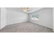 Neutral bedroom featuring plush carpet, ceiling fan, and a bright window at 3718 Mossy Limb Ct, Palmetto, FL 34221