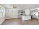 Modern kitchen featuring grey cabinets, stainless steel appliances, and a granite island with pendant lighting at 3718 Mossy Limb Ct, Palmetto, FL 34221