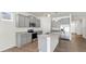 Stylish kitchen featuring gray cabinets, stainless steel appliances, and an island with a sink and granite countertop at 3718 Mossy Limb Ct, Palmetto, FL 34221