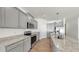 This kitchen features granite countertops, stainless steel appliances, and gray cabinets at 3718 Mossy Limb Ct, Palmetto, FL 34221