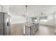 This open-concept kitchen features granite countertops, stainless appliances, and tile floors at 3718 Mossy Limb Ct, Palmetto, FL 34221