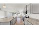 This spacious kitchen features granite countertops, stainless steel appliances, and gray cabinets at 3718 Mossy Limb Ct, Palmetto, FL 34221
