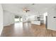 Expansive living space showcases wood-look floors, a sliding glass door, and views of the contemporary kitchen at 3718 Mossy Limb Ct, Palmetto, FL 34221