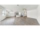 Large living room adjacent to the kitchen, featuring wood-look flooring and providing ample space for relaxation at 3718 Mossy Limb Ct, Palmetto, FL 34221