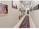 Bright hallway with hardwood floors and artwork at 401 Quay Commons # 803, Sarasota, FL 34236