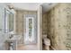 Half bathroom with pedestal sink and access to backyard at 4301 Brackenwood Ct, Sarasota, FL 34232