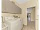 Laundry room with washer, dryer, and storage cabinets at 524 Oak Bay Dr, Osprey, FL 34229