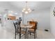 Open dining room features a glass table and flows into the kitchen creating a cohesive living space at 5525 Bountiful Dr # 20, Sarasota, FL 34233