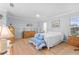 Spacious main bedroom featuring wood flooring, natural light, and neutral tones creating a serene and inviting atmosphere at 5525 Bountiful Dr # 20, Sarasota, FL 34233