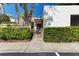 Front view of a single-story house with well-manicured hedges and a walkway at 597 Lakeside Dr, Bradenton, FL 34210